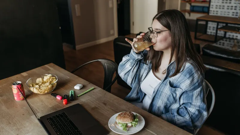 A woman working on a laptop in a café