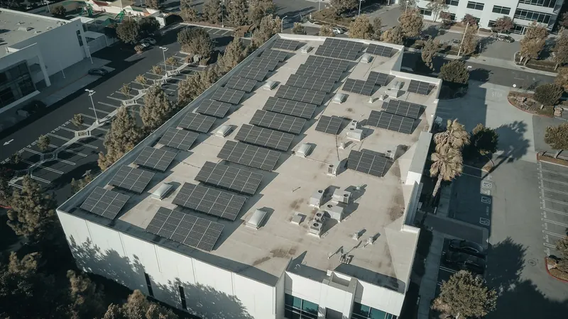 Aerial view of a commercial building with solar panels on the roof